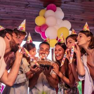 People,celebration and lifestyle concept-smiling friends celebrate birthday at night party.